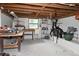Spacious basement with exposed wooden ceiling beams and abundant storage options at 9461 Cr 657, Bushnell, FL 33513