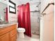 Bathroom features a modern walk-in shower, cherry wood cabinets, a granite vanity countertop, and tiled floors at 9461 Cr 657, Bushnell, FL 33513