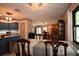 Dining area leading to kitchen and fireplace, complemented by a stylish chandelier at 9461 Cr 657, Bushnell, FL 33513