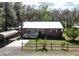 Charming single-story home with a white-trimmed porch and a convenient carport at 9461 Cr 657, Bushnell, FL 33513