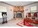 Close-up of the stone fireplace in the living room with tile floor, wood mantel, and classic decor at 9461 Cr 657, Bushnell, FL 33513