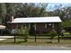 Quaint home with a metal roof and a cozy front porch, complemented by a rustic fence at 9461 Cr 657, Bushnell, FL 33513