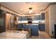 Modern kitchen with blue cabinets, granite countertops and stainless steel appliances at 9461 Cr 657, Bushnell, FL 33513