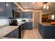 Updated kitchen with granite countertops, stainless steel appliances and blue cabinets at 9461 Cr 657, Bushnell, FL 33513