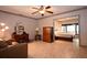 Living room with tile floors, ceiling fan, and a view into the bedroom at 9461 Cr 657, Bushnell, FL 33513