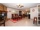 Comfortable living room featuring a stone fireplace, tile flooring, and classic decor at 9461 Cr 657, Bushnell, FL 33513