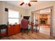 Office space featuring wood-look floors and a view of a stone fireplace at 9461 Cr 657, Bushnell, FL 33513