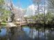 Waterfront property featuring a boat ramp, mature trees, and serene water views at 9461 Cr 657, Bushnell, FL 33513
