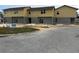 New two-story townhomes feature a yellow facade with grey accents and professional signage at 222 Carpenters Way # 68, Lakeland, FL 33805