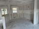 Area intended for a kitchen, with window and bar-like drywall structure at 222 Carpenters Way # 68, Lakeland, FL 33805