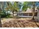 Private fenced backyard featuring mature trees and a screened porch, perfect for outdoor entertaining at 5054 Fairfield Dr, Lakeland, FL 33811