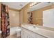 Bathroom with shower-tub combo, neutral tile, and a modern vanity with ample countertop space at 5054 Fairfield Dr, Lakeland, FL 33811