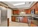 This kitchen features stainless steel appliances, dark wood cabinets, and tiled floors at 5054 Fairfield Dr, Lakeland, FL 33811