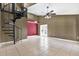 Open living space with neutral tile flooring, ceiling fan, and access to the rear patio at 5054 Fairfield Dr, Lakeland, FL 33811