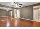 Main bedroom with laminate floors, ceiling fan, walk-in closet, and adjoining bathroom at 5054 Fairfield Dr, Lakeland, FL 33811