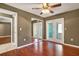 Laminate floor main bedroom with mirrored closet doors, ceiling fan and backyard access at 5054 Fairfield Dr, Lakeland, FL 33811