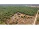 Expansive aerial view of a homestead with lush greenery and diverse landscape, presenting serene seclusion at 15675 Sw 33Rd St, Ocala, FL 34481