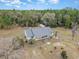 Aerial view of single-story home, fenced yard and surrounding wooded acreage at 15675 Sw 33Rd St, Ocala, FL 34481