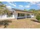 Inviting exterior featuring a covered porch with classic columns and neutral paint for a welcoming appeal at 15675 Sw 33Rd St, Ocala, FL 34481