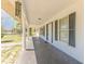 Welcoming porch with classic columns and neutral paint, perfect for enjoying the outdoors in style at 15675 Sw 33Rd St, Ocala, FL 34481