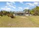 Generously sized yard featuring scattered palms and secure fencing, creating a private outdoor retreat at 15675 Sw 33Rd St, Ocala, FL 34481