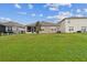 Expansive backyard featuring a lush lawn, a screened-in porch, and mature landscaping at 2723 Elmbrooke Way, Edgewater, FL 32141