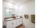Well-lit bathroom with dual sinks, granite countertop, and walk-in shower at 2723 Elmbrooke Way, Edgewater, FL 32141