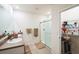 Bright bathroom featuring double sinks, granite countertops, and a glass enclosed shower at 2723 Elmbrooke Way, Edgewater, FL 32141