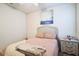 Bright bedroom featuring a bed, a nightstand with drawers, and a blue painting on the wall at 2723 Elmbrooke Way, Edgewater, FL 32141