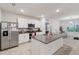 Modern kitchen with stainless steel appliances, granite countertops, and white cabinetry at 2723 Elmbrooke Way, Edgewater, FL 32141