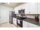 Contemporary kitchen with stainless steel appliances, granite countertops, and plenty of storage at 2723 Elmbrooke Way, Edgewater, FL 32141