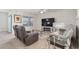 Cozy living room featuring comfortable seating, a large TV, and modern decor at 2723 Elmbrooke Way, Edgewater, FL 32141
