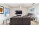 Cozy living room with large TV, comfortable seating, and bright natural light at 2723 Elmbrooke Way, Edgewater, FL 32141