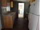 Traditional kitchen featuring wood cabinets, a stainless steel dishwasher, and neutral countertops at 4801 Avon St, Lake Wales, FL 33859