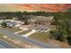 Aerial view of single Gathering homes and surrounding woodland area against an orange sunset backdrop at 524 Marion Oaks Blvd, Ocala, FL 34473