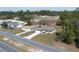 An aerial view of a charming single-story home with a well-manicured lawn and a long driveway at 524 S Marion Oaks Blvd, Ocala, FL 34473