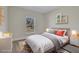 Cozy bedroom with grey laminate flooring, a queen bed, bright decor, and a window providing natural light at 524 Marion Oaks Blvd, Ocala, FL 34473
