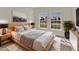 This bedroom features neutral decor, a wooden headboard, and natural light from dual windows at 524 Marion Oaks Blvd, Ocala, FL 34473