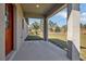 A gray covered porch has a painted concrete floor with a matching painted support column at 524 Marion Oaks Blvd, Ocala, FL 34473