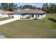 Aerial view of a single-story home with well-manicured lawn and long driveway on a sunny day at 524 Marion Oaks Blvd, Ocala, FL 34473
