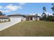 Charming single Gathering home features a well-manicured lawn and attached garage at 524 Marion Oaks Blvd, Ocala, FL 34473