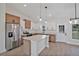Bright kitchen with stainless steel appliances, center island, and modern two-tone cabinetry at 524 Marion Oaks Blvd, Ocala, FL 34473