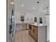 Well-designed kitchen with a large island, stainless steel appliances, and modern, two-tone cabinetry at 524 Marion Oaks Blvd, Ocala, FL 34473