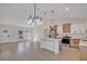 Bright living room and kitchen area with modern light fixtures, stainless steel appliances, and beautiful flooring at 524 Marion Oaks Blvd, Ocala, FL 34473