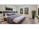 Staged primary bedroom features a tufted headboard and an accent painting at 524 Marion Oaks Blvd, Ocala, FL 34473