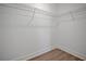 A simple walk-in closet with bare walls, laminate floors and a single wire rack across the top at 524 Marion Oaks Blvd, Ocala, FL 34473