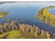 Stunning aerial perspective of a lake with a tranquil shoreline and lush wetlands at 5261 Waterwood Dr, Bartow, FL 33830