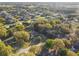 Aerial view showcases the layout of the neighborhood, highlighting the spacious lots and mature trees throughout at 5261 Waterwood Dr, Bartow, FL 33830