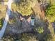 From above, this property features a screen enclosed pool and expansive yard in a lush, tree-filled neighborhood at 5261 Waterwood Dr, Bartow, FL 33830