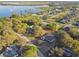 Aerial view of a residential neighborhood with lake access, featuring well-maintained homes and lush landscaping at 5261 Waterwood Dr, Bartow, FL 33830